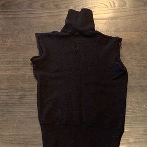 Black Balenciaga turtleneck sleeveless top.